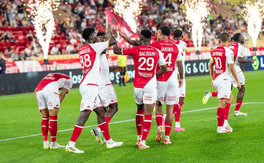 AS Monaco players celebrate a positive moment during a football match,