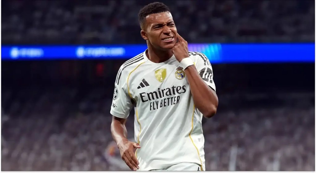Kylian Mbappé reacts while wearing Real Madrid’s white home kit during a match